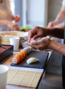 Guests learning to prepare authentic Japanese sushi during a hands on cooking workshop in Tokyo.