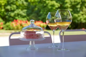 Glasses of Champagne and French macarons served in the gardens of a Champagne estate