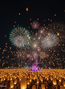 Fireworks and lanterns lighting the night sky during Yi Peng in Chiang Mai