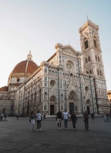 Florence Cathedral and Giotto's Bell Tower viewed from Piazza del Duomo during the early evening.