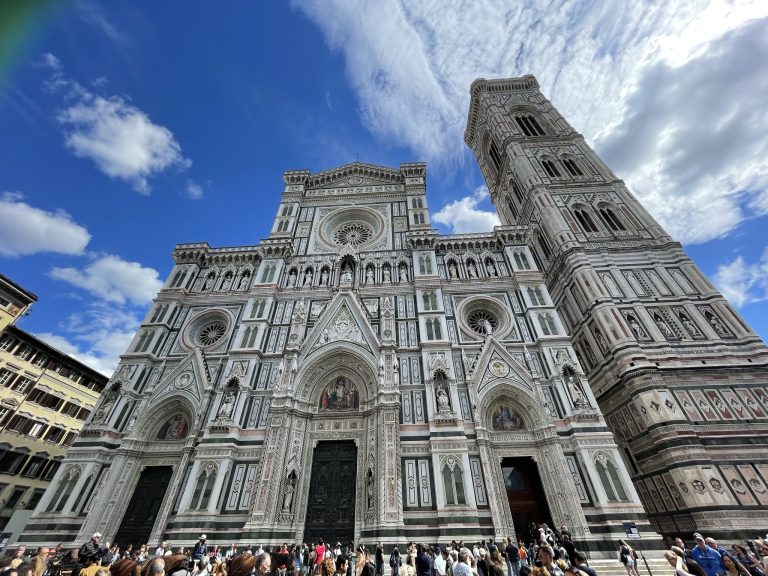 florence-cathedral-duomo-facade The ornate façade of Florence Cathedral beneath a bright blue sky.