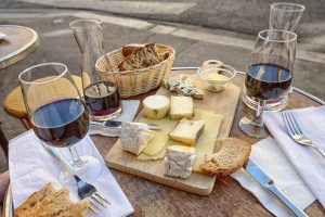 French cheese and wine served at a table in Paris