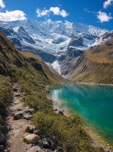 Turquoise waters of Humantay Lake beneath the snow covered Salkantay Mountains in Peru.