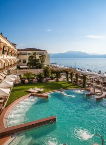 Luxury spa resort overlooking Lake Garda with thermal pools, landscaped gardens, and mountain views.
