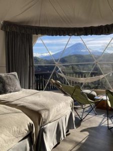 Luxury glamping dome overlooking Mount Fuji in Kawaguchiko with panoramic windows, private deck and forest surroundings.