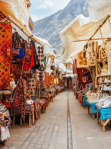 Colourful artisan market stalls selling textiles, handicrafts and souvenirs in Pisac, Peru.