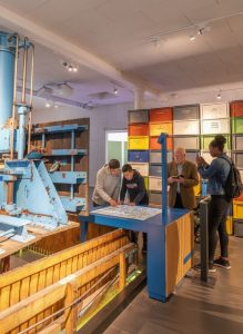 Visitors exploring interactive exhibits at Pressoria, the Champagne interpretation centre