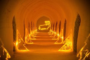 Illuminated ice art installation inside the Sorrisniva Ice Hotel in Alta, Norway, showcasing handcrafted Arctic sculptures.