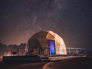 Luxury glamping dome beneath a star filled sky in the Wadi Rum desert.