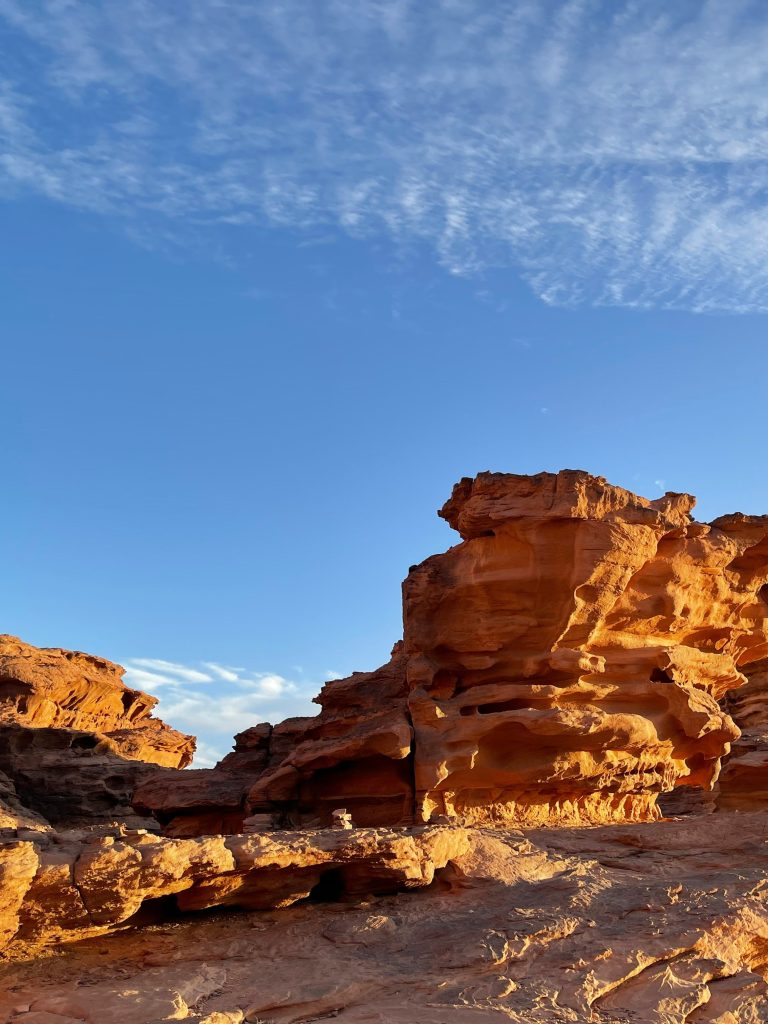 Unique sandstone rock formations rising from the desert floor in Wadi Rum, Jordan.